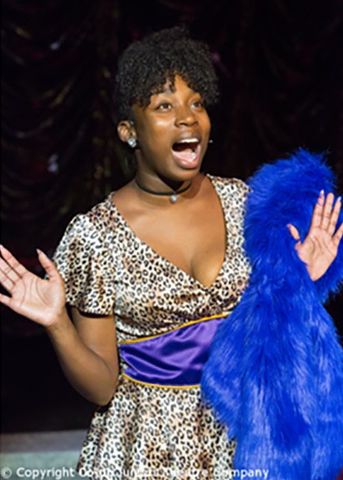 Deloris Van Cartier in leopard skin short dress with blue fake fur costume. Scene from Sister Act the Musical.